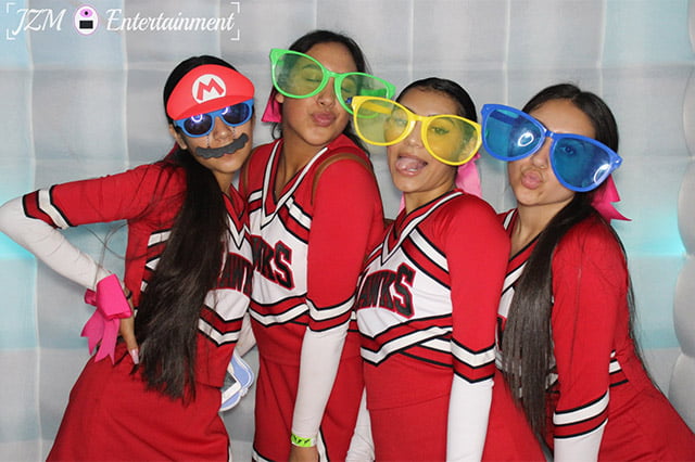 High School team posing for camera & wearing glasses props
